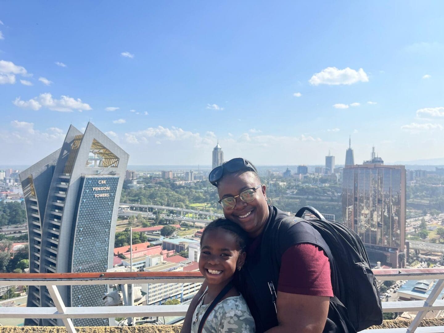 Smiling adult and child with city skyline